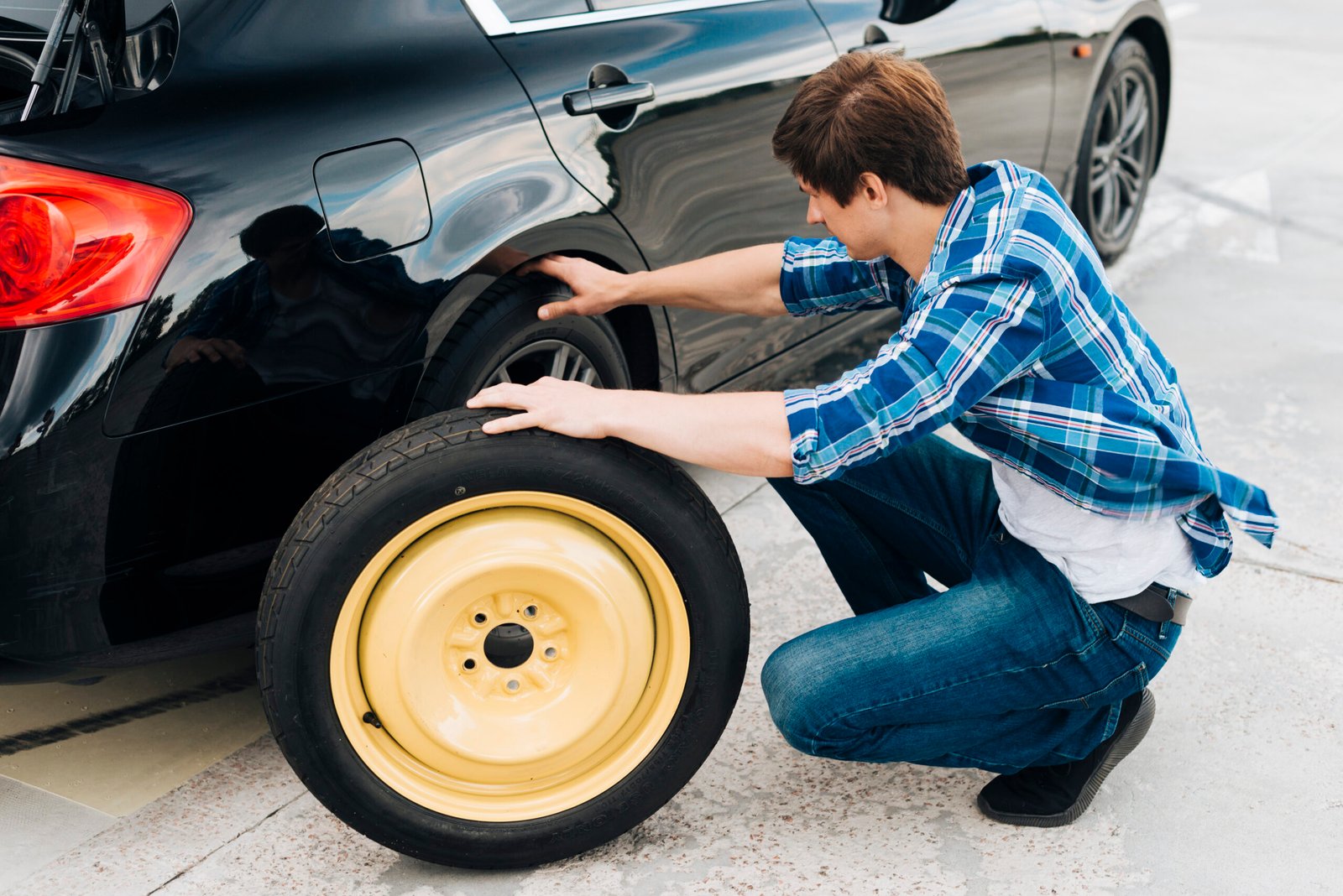 full-shot-man-changing-car-tire